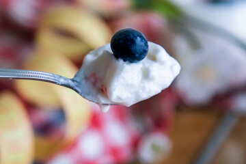 spoon with natural yogurt, concept of diet and health