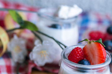 natural yogurt with strawberries and blueberries, concept of diet and health