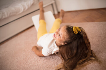 Little girl having fun in her bedroom.