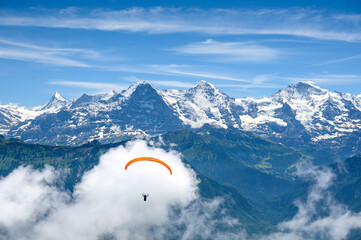paragliding flyer in the Bernese Alps in front of Eiger Mönch and Jungfrau