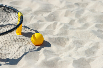 Spike ball game with yellow ball on sand. Summer game concept