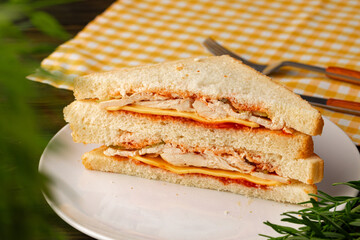 Double club sandwich served on plate on wooden table