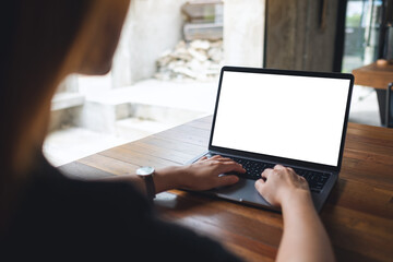 Mockup image of a woman using and typing on laptop computer with blank white desktop screen in cafe