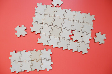 Empty jigsaw puzzle on orange background. Business concept background. Team works, human resources, work process, solution.