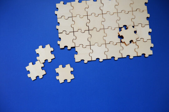 Empty jigsaw puzzle on blue background. Business concept  background. Team works, human resources, work process, solution. 