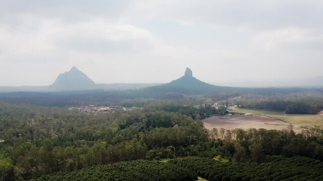 Mount Coonowrin And Mount Beerwah On A Foggy Day At Glass House Mountains In Sunshine Coast Region, QLD, Australia. - aerial