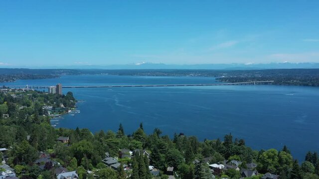Drone flying over Madison Valley in Seattle wit Lake Washington, North Cascades, 520 Bridge and Kirkland views.