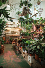 Vertical image of flower shop with large numbers of different flowers and plant in pots on the...