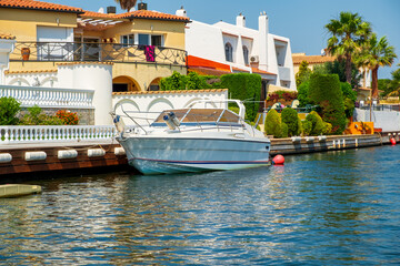 Beautiful and cozy resort town, Empuriabrava town in summer atmosphere, canal with yachts and small boats, Costa Brava, Catalonia