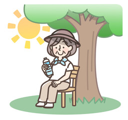 木陰で休憩するおばあさん