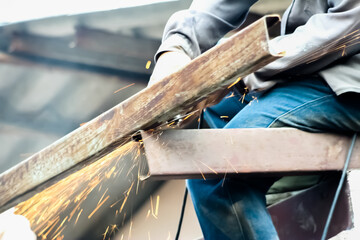 Close up welding metal for  roof repair  by worker