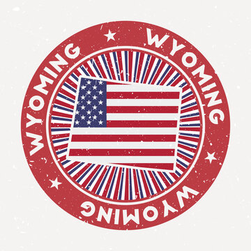 Wyoming round stamp. Logo of us state with flag. Vintage badge with circular text and stars, vector illustration.