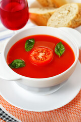 Gazpacho tomato soup, bowl of vegetable soup with basil