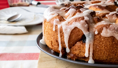 Freshly baked cake with red fruits and white sugar frosting - Chelsea bun