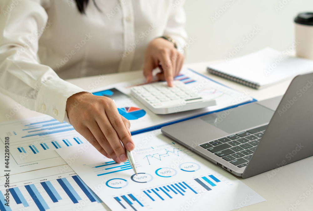 Wall mural business woman working in finance and accounting analyze financial budget in the office