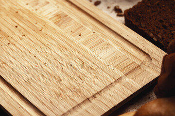 Wooden board with bread crumbs close up