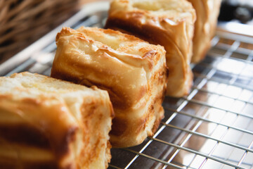  loaf of Bread .Grilled crispy toast on the wire rack. prepared for snacks with basket as background.