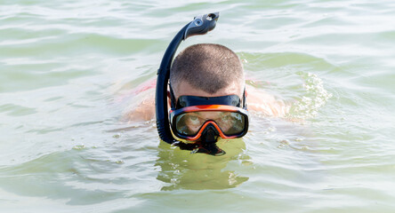 Man with snorkeling equipment snorkel and scuba mask