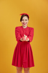 Happy young woman holding a gift box