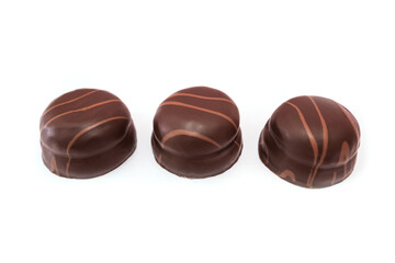 three chocolate candies isolated on white background.
