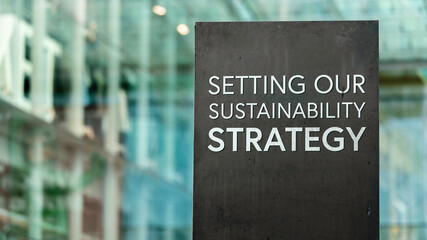 Setting our sustainability strategy on a city-center sign in front of a modern office building 