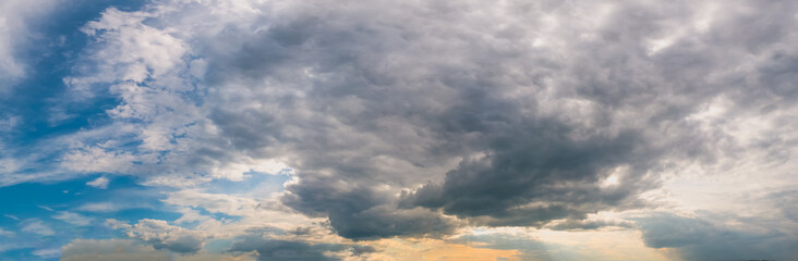 Panoramic view of beautiful thunderclouds. Dramatic dark blue sky background. Rainy weather.