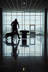 Fototapeta premium Security worker with detection dog checking luggage at airport