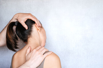 A chiropractor performing a manipulation on woman's neck and administering of spinal adjustments to...