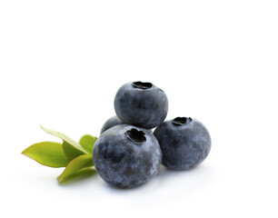 Isolated blueberries on a white background. Three berries with green leaves.