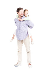 Vertical full length isolated shot of modern Caucasian father wearing casual clothes carrying his lovely daughter on back, white background