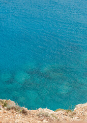 Crystal clear sea water with stones under water
