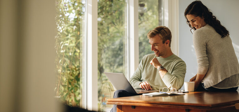 Happy couple enjoying their time at home - Powered by Adobe