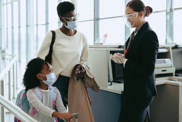 Family of two at airport traveling during pandemic