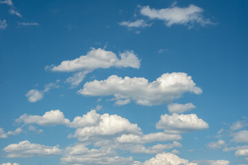 Blue sky with fluffy white clouds. Perfect natural sky background, wallpaper, greeting card