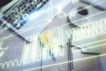 Education hologram drawings over computer on the desktop background. Top view. Multi exposure.