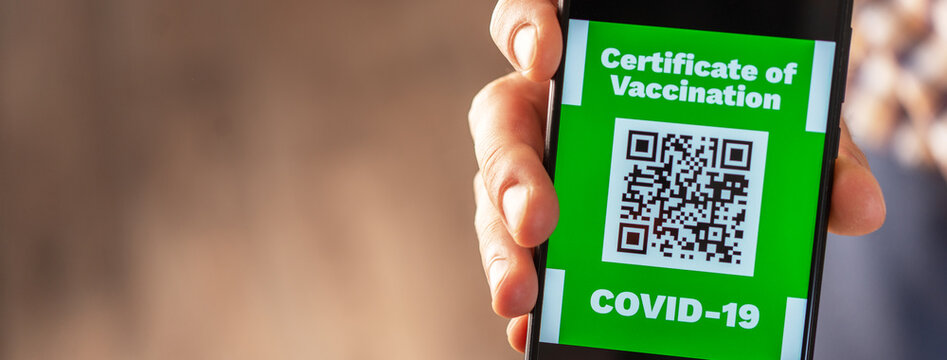 A man shows a qr code in a smartphone containing information about vaccination against coronavirus
