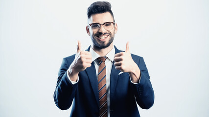 successful businessman showing thumbs up while smiling at camera isolated on white
