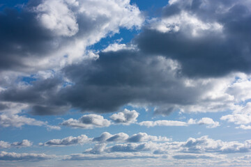 dark and white clouds on blue sky, selective focus