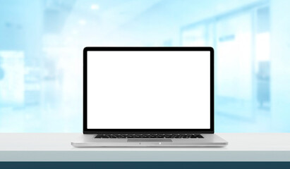Laptop or notebook with blank screen on hospital service counter in blurry background with operating room or examination room for banner or wallpaper healthcare and medical.