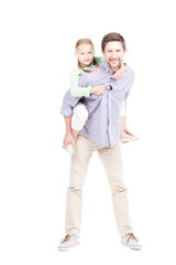 Vertical full length isolated shot of joyful mature man with beard on face having fun with his little daughter carrying her on back, white background