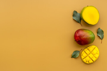 Mango fruit and mango cubes top view. Tropical fruits background