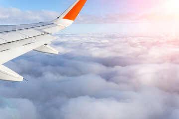 wing of the plane on the background of clouds. Travel concept