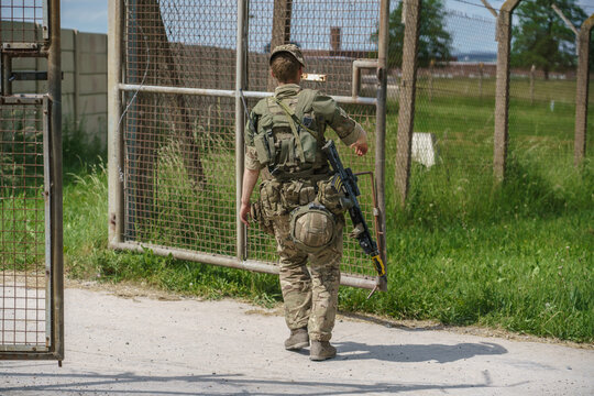 British army soldier with SA80 rifle guarding a military compound entrance on Salisbury Plain, Wiltshire