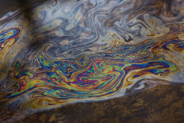 oil spills on puddle background, abstract gasoline nature pollution concept