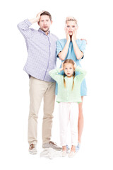 Vertical full length shot of modern man and woman standing with their little daughter astonished at something, white background