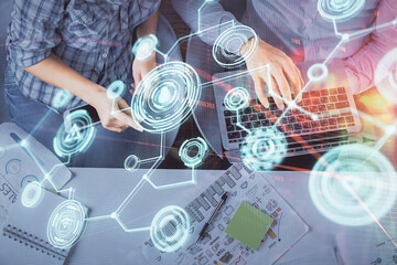 Double exposure of man and woman working together and social network theme hologram drawing. Computer background. connecting concept. Top View.