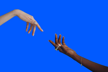 Caucasian and African American hand reaching out to each other.
