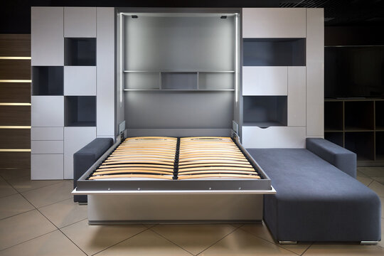 Bedroom interior flat with Vertical Murphy Wall Bed, roll-away pull out bed stored into wardrobe with lots of shelves and drawers, minimalist interior design, modern architecture concept.