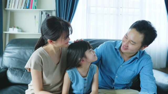 Portrait of Asian happy family, sit on sofa in living room at house.