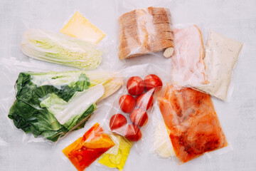 Salad dinner set: chicken, lettuce, tomatoes, peking cabbage, cheese, bacon, bread, olive oil sauces and spices. A set for delivering food for dinner on a white background. I cook at home.